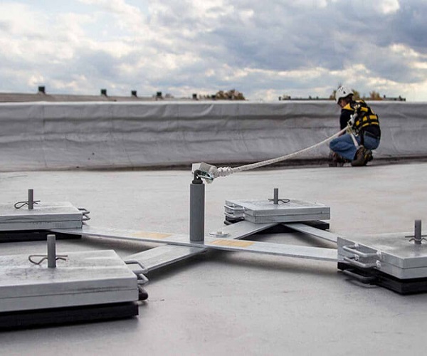 ;person working on a roof attached to a Mobile man anchor