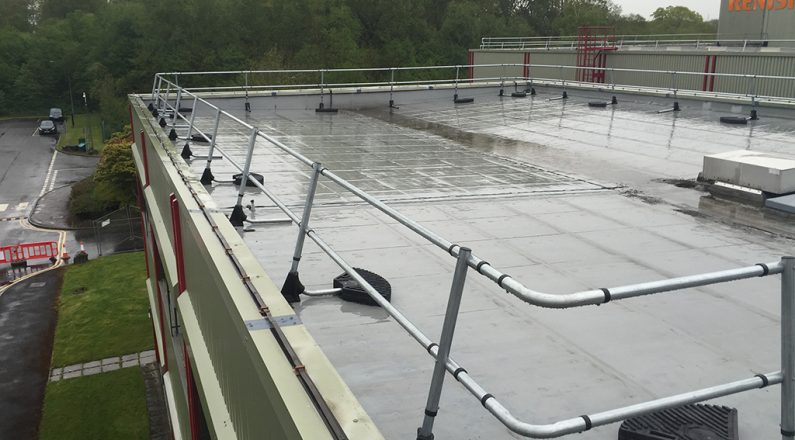 Raked back guardrail on a commercial roof