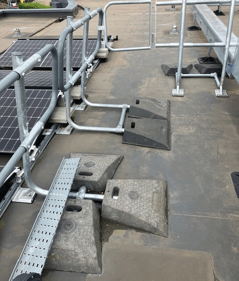 badly designed fall protection guardrail on a rooftop.