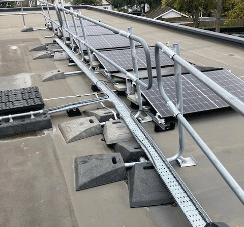 guardrail system on a roof with too many base feet, some are on top of each other. Badly designed system