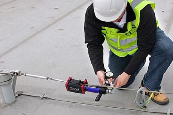 Worker testing a horizontal lifeline cable