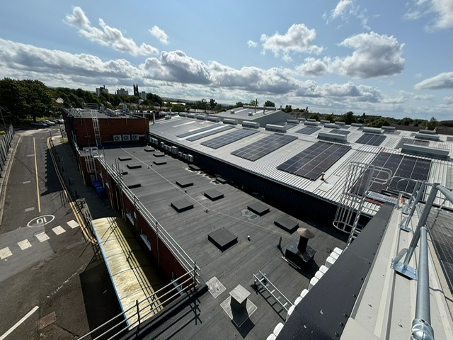 Roof with different levels and fall protection including guardrail and access ladders 