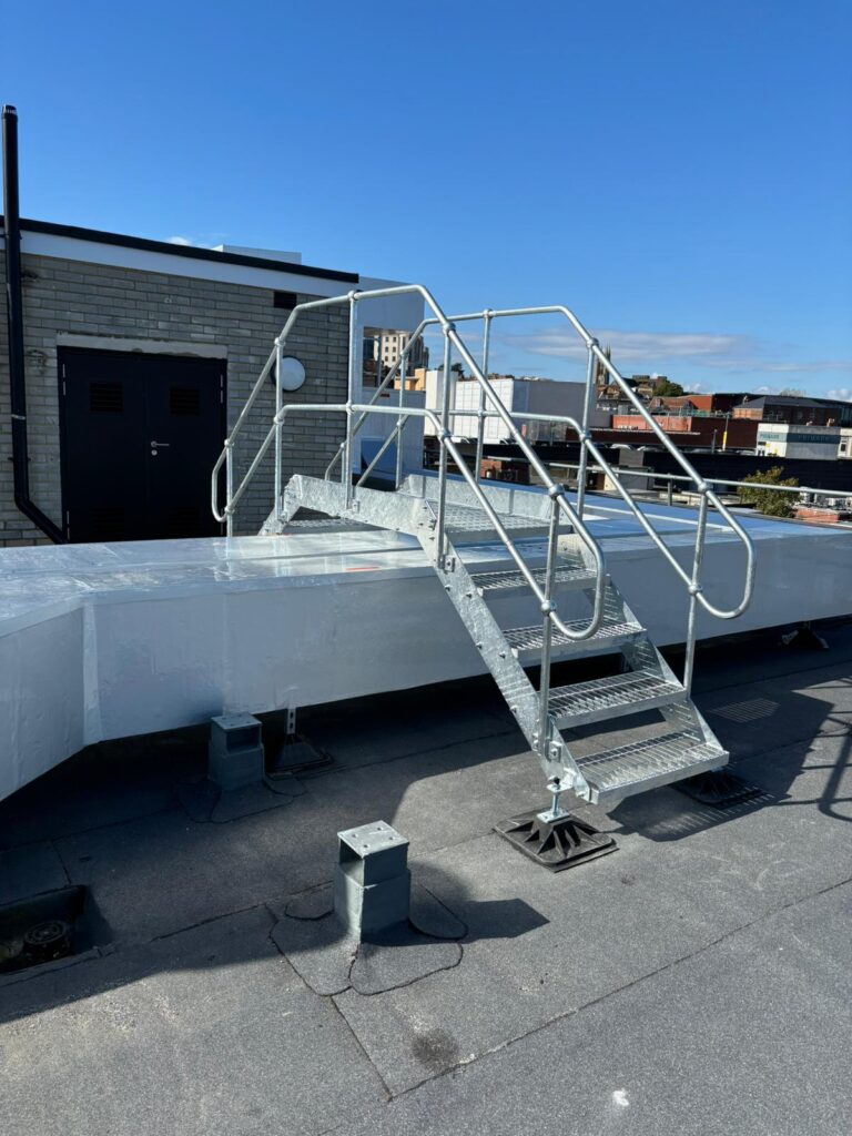 Step over unit for safe access over ductwork on a roof